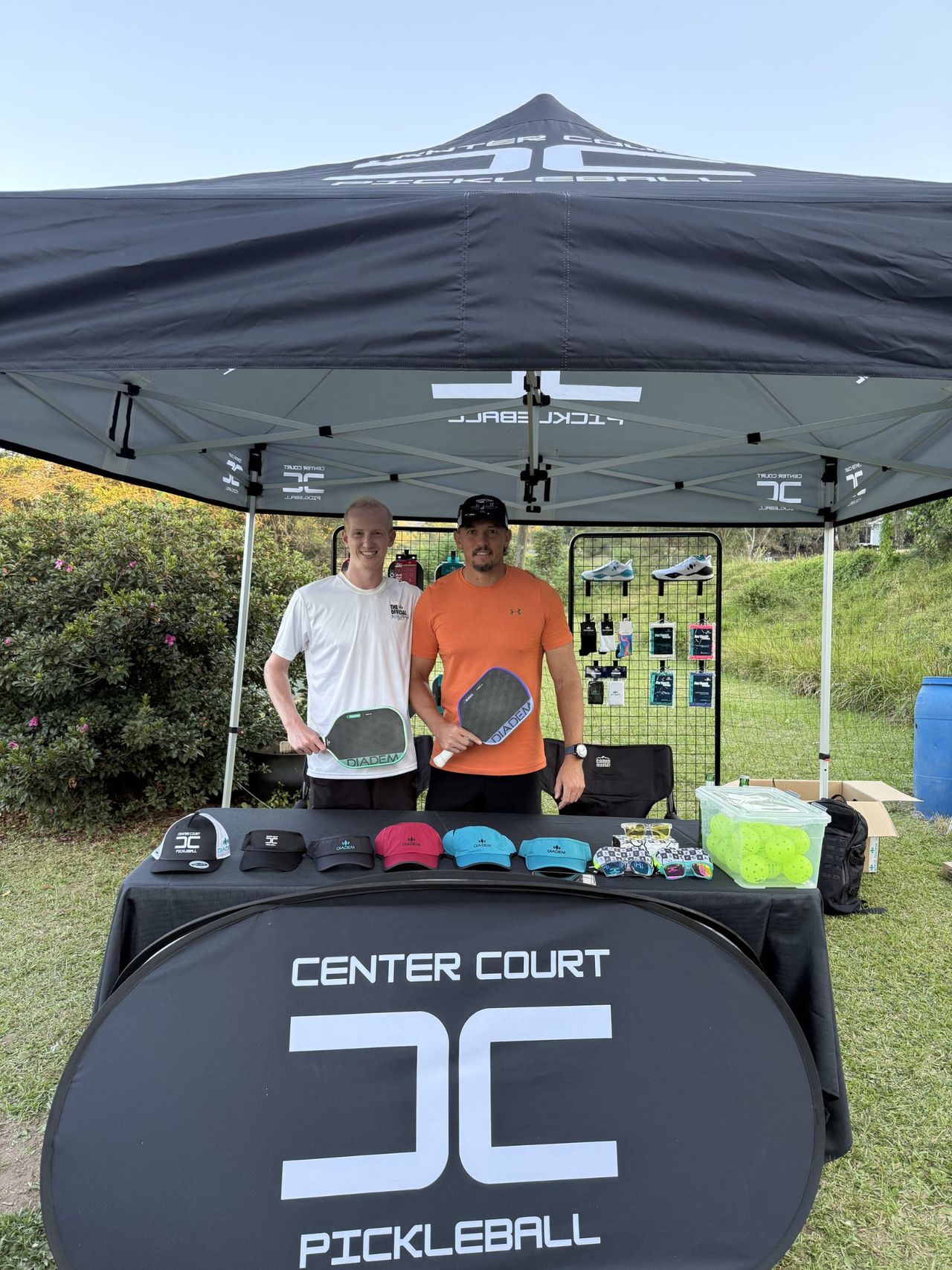 The Center Court stand at a KwaZulu-Natal pickleball event, with paddles, caps and equipment on display.